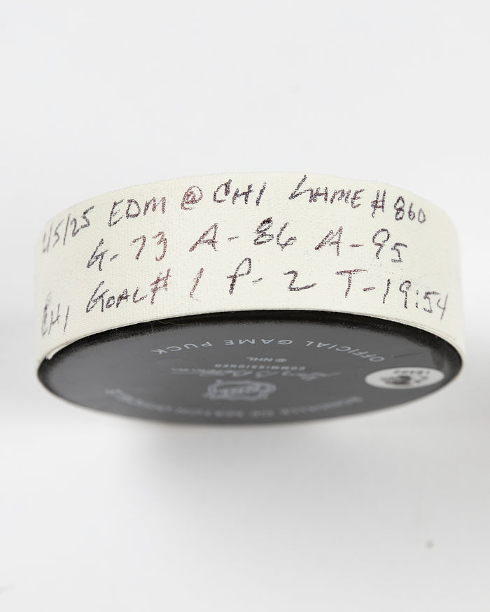 official Chicago Blackhawks game-used goal puck scored by Lukas Reichel on February 5, 2025 - side lay flat of tape