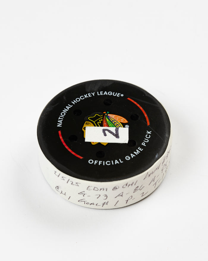 official Chicago Blackhawks game-used goal puck scored by Lukas Reichel on February 5, 2025 - front angle lay flat