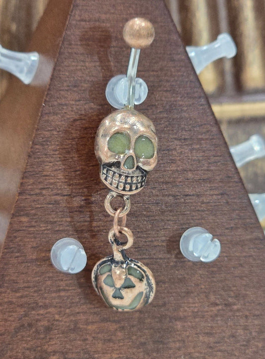 Painful Pleasures Skull & Pumpkin Glow Navel Ring in 14G Surgical Steel