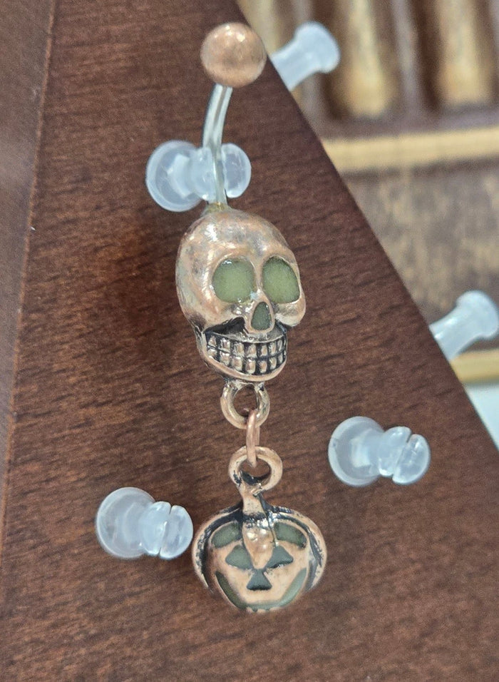 Painful Pleasures Skull & Pumpkin Glow Navel Ring in 14G Surgical Steel