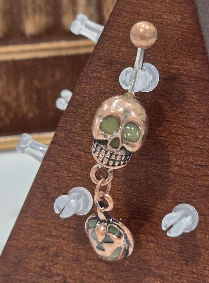 Painful Pleasures Skull & Pumpkin Glow Navel Ring in 14G Surgical Steel