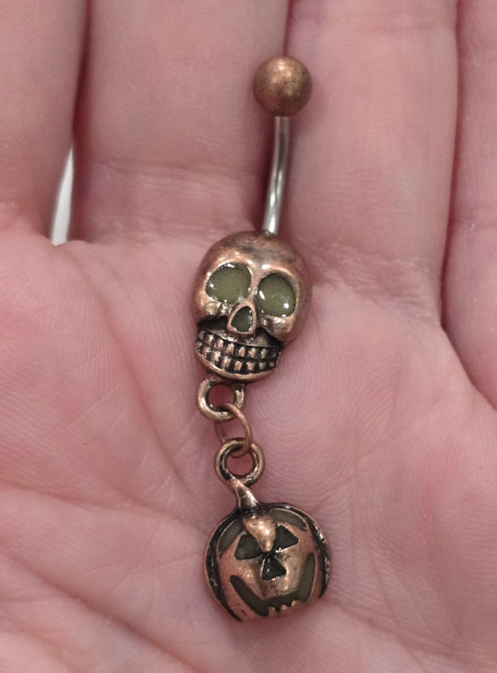 Painful Pleasures Skull & Pumpkin Glow Navel Ring in 14G Surgical Steel