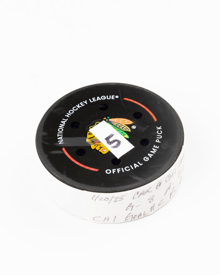 official Chicago Blackhawks game used goal puck scored by Ryan Donato against the Carolina Hurricanes on January 20, 2025 - front angle lay flat